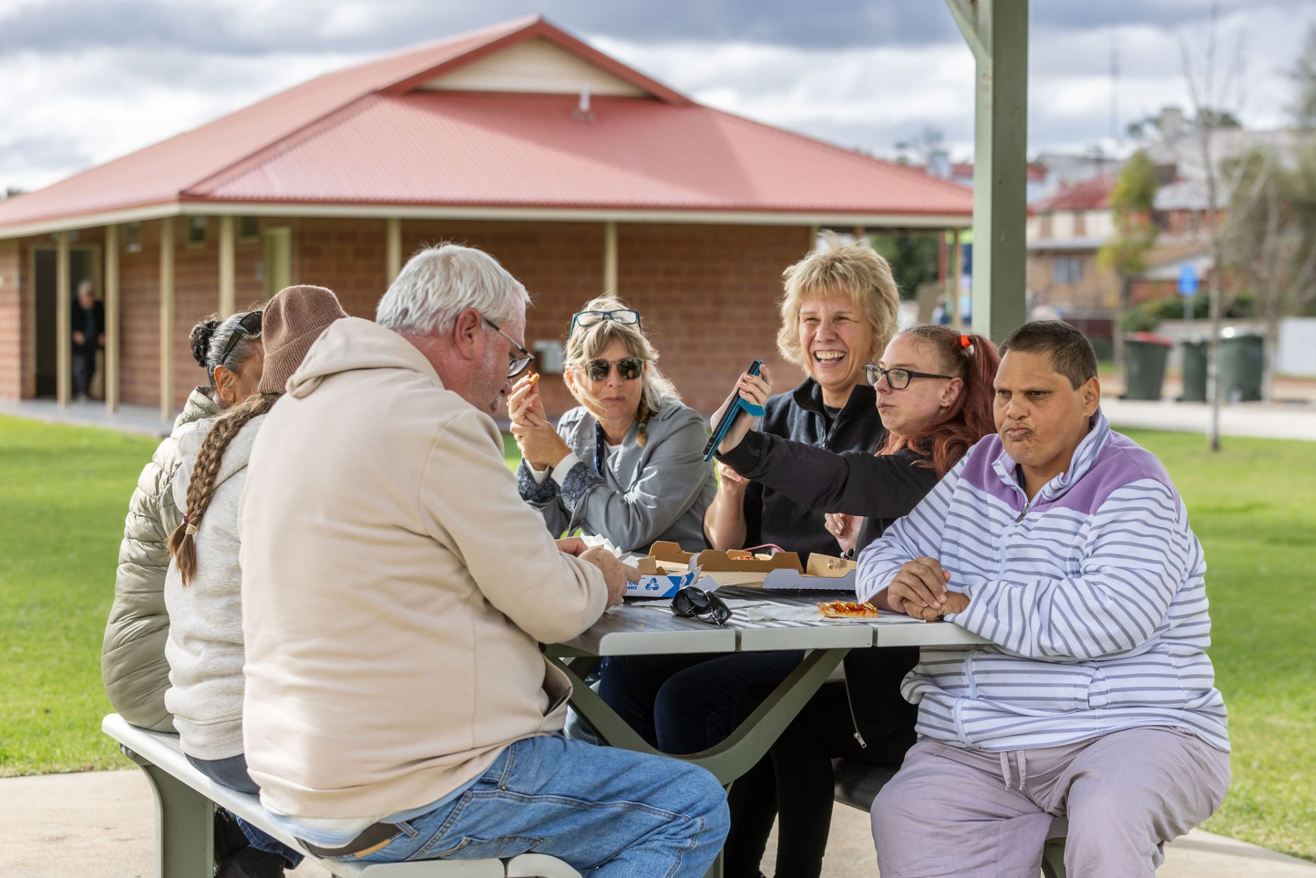 A group of people eating outdoors