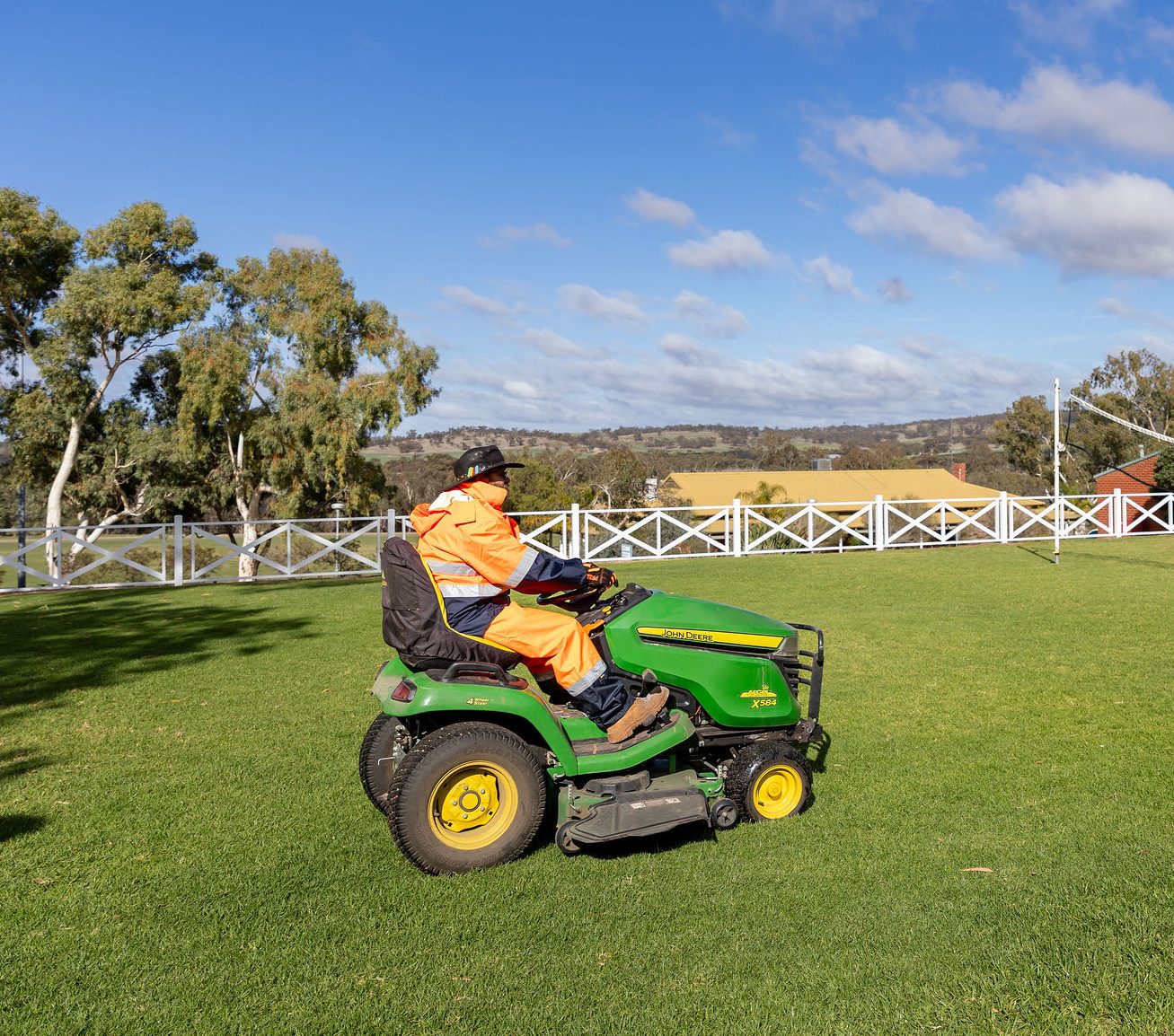 A person driving a lawnmower